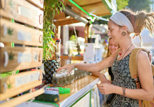 KushMapper Woman Shopping At Cannabis Vendor Station Top Cannabis Products Of 2024 Blog